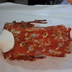 NAIF Women's Red Floral Blouse With The Sleeves Cut Out With tie.
